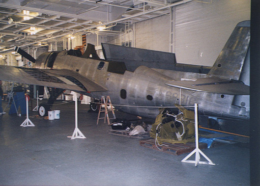 TBM_03.jpg - Disassembly of plane started. Canopy removed and 50mm gun turret on deck.