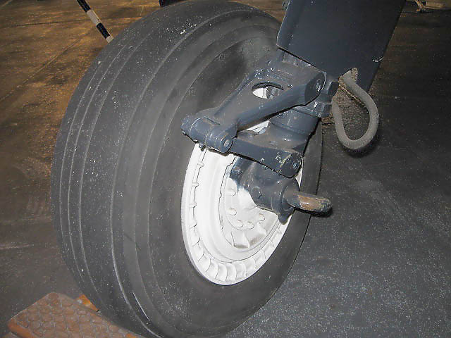 TBM_43.jpg - Front tire and hub assembly. Large eyehook is attachment point for bridle to move plane around.