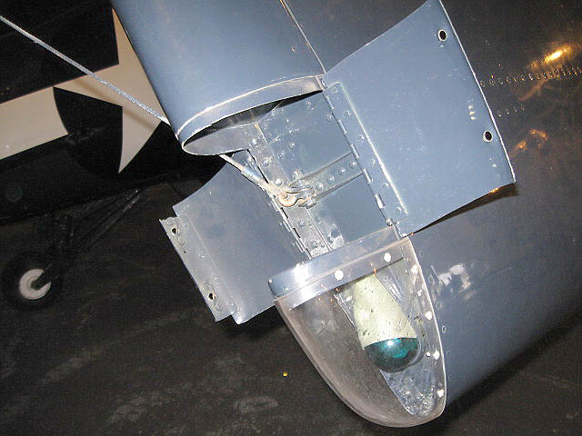 TBM_49.jpg - Navigational light and small compartment to stow cable that holds wing back in folding position. Attachment point is an eyehook in the forward surface of the elevator.